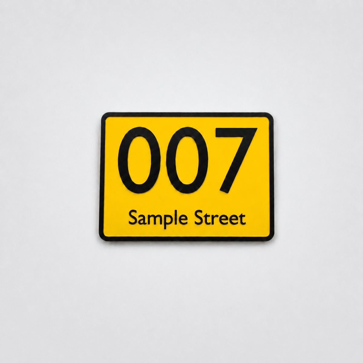 Yellow custom house number sign with black text