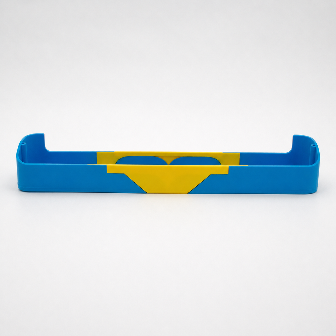 Modular blue and yellow refrigerator shelf on a light studio background