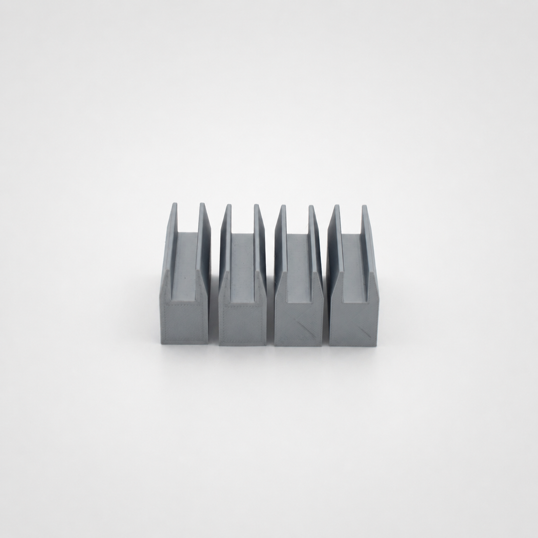 Four lightweight U-profile guides on a light studio background