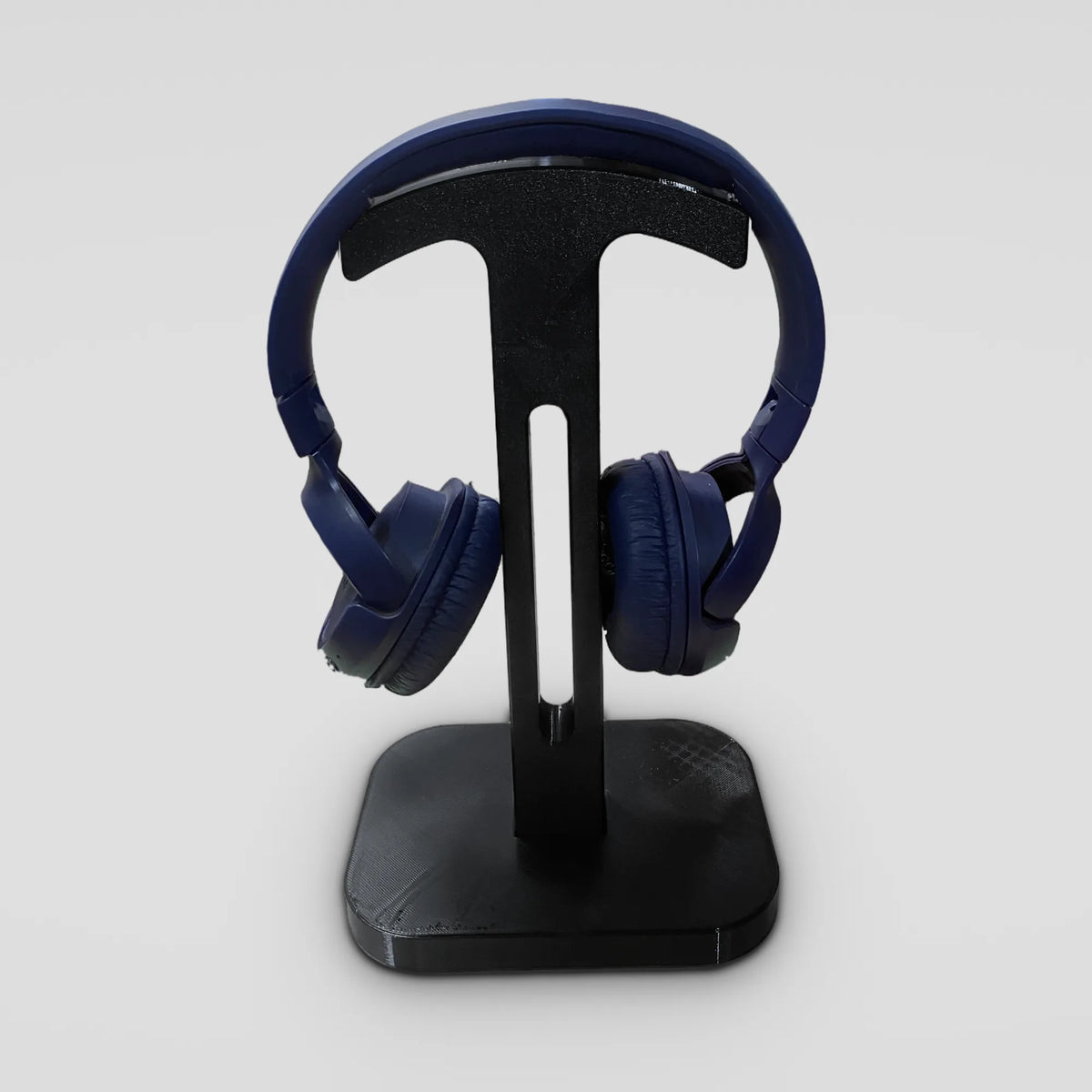Black 3D-printed headphone stand with blue on-ear headphones