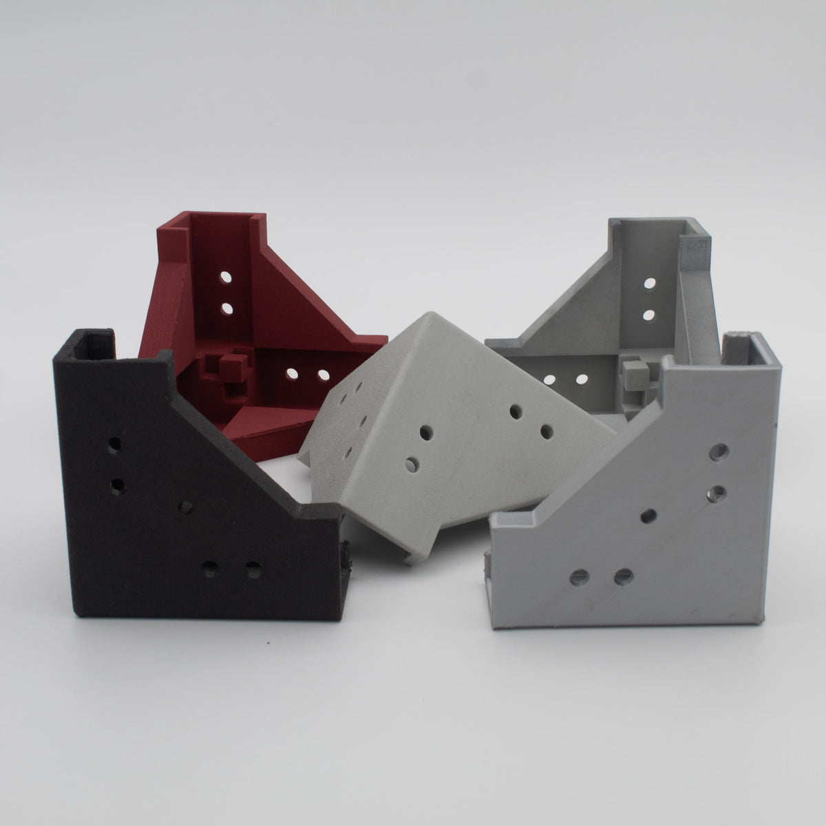 Black, red and grey 3D-printed corner brackets