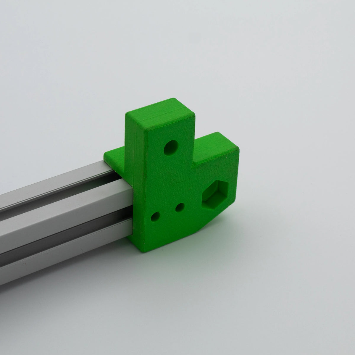 Green 3D-printed bracket on aluminium profile