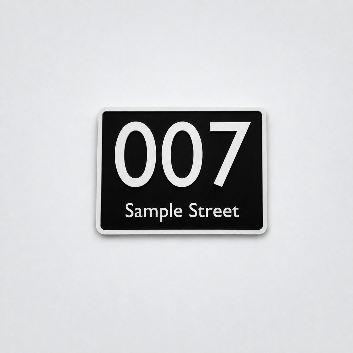 Black custom house number sign with white text