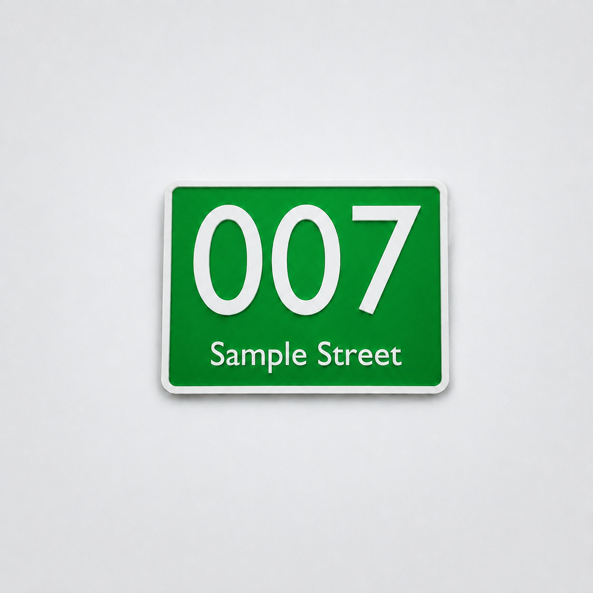 Green custom house number sign with white text