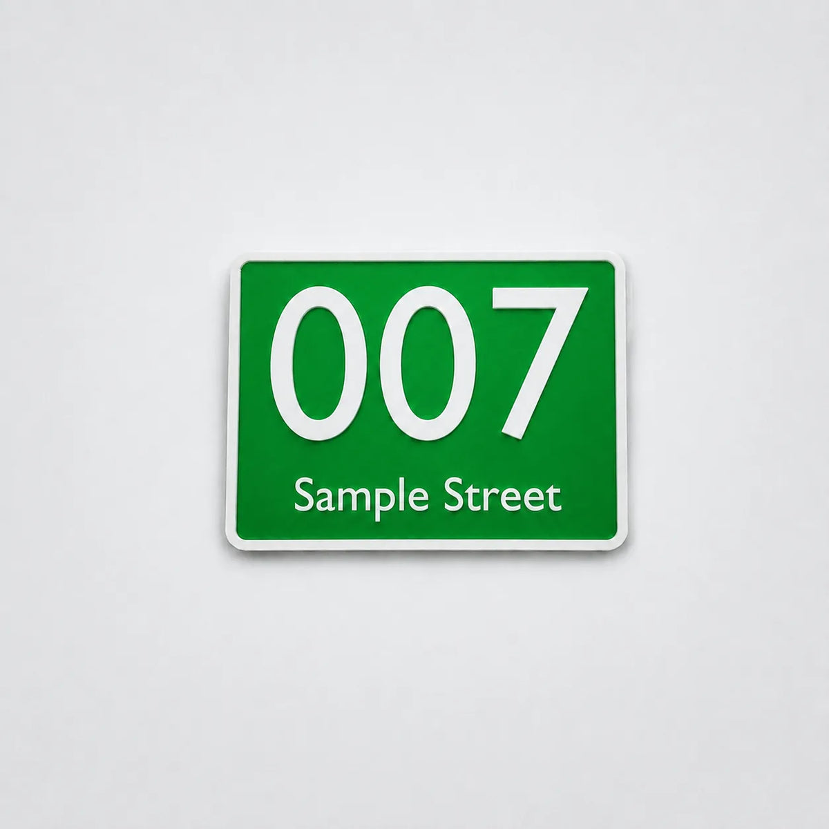 Green 3D-printed house number sign with white text