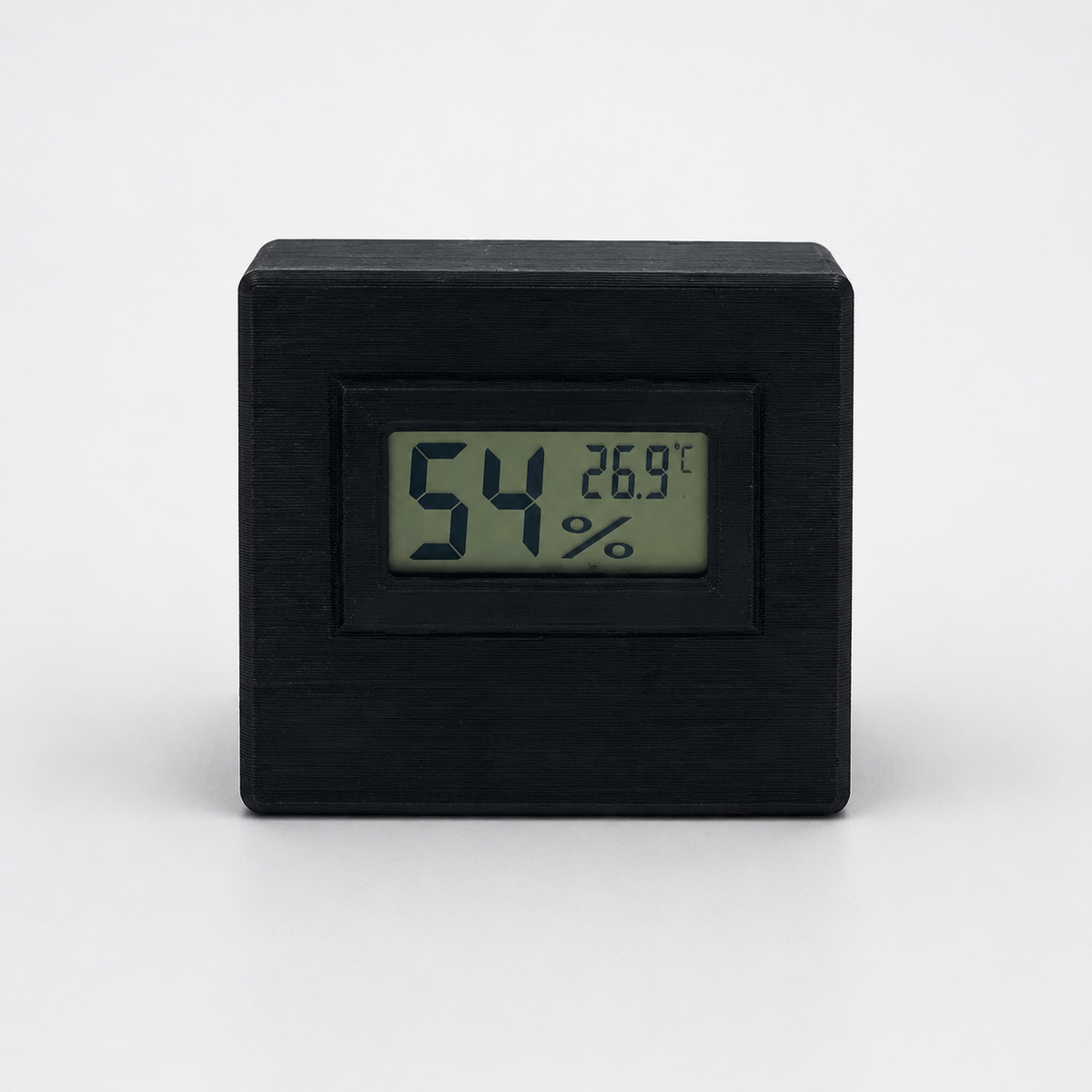 Black digital temperature and humidity sensor, front view