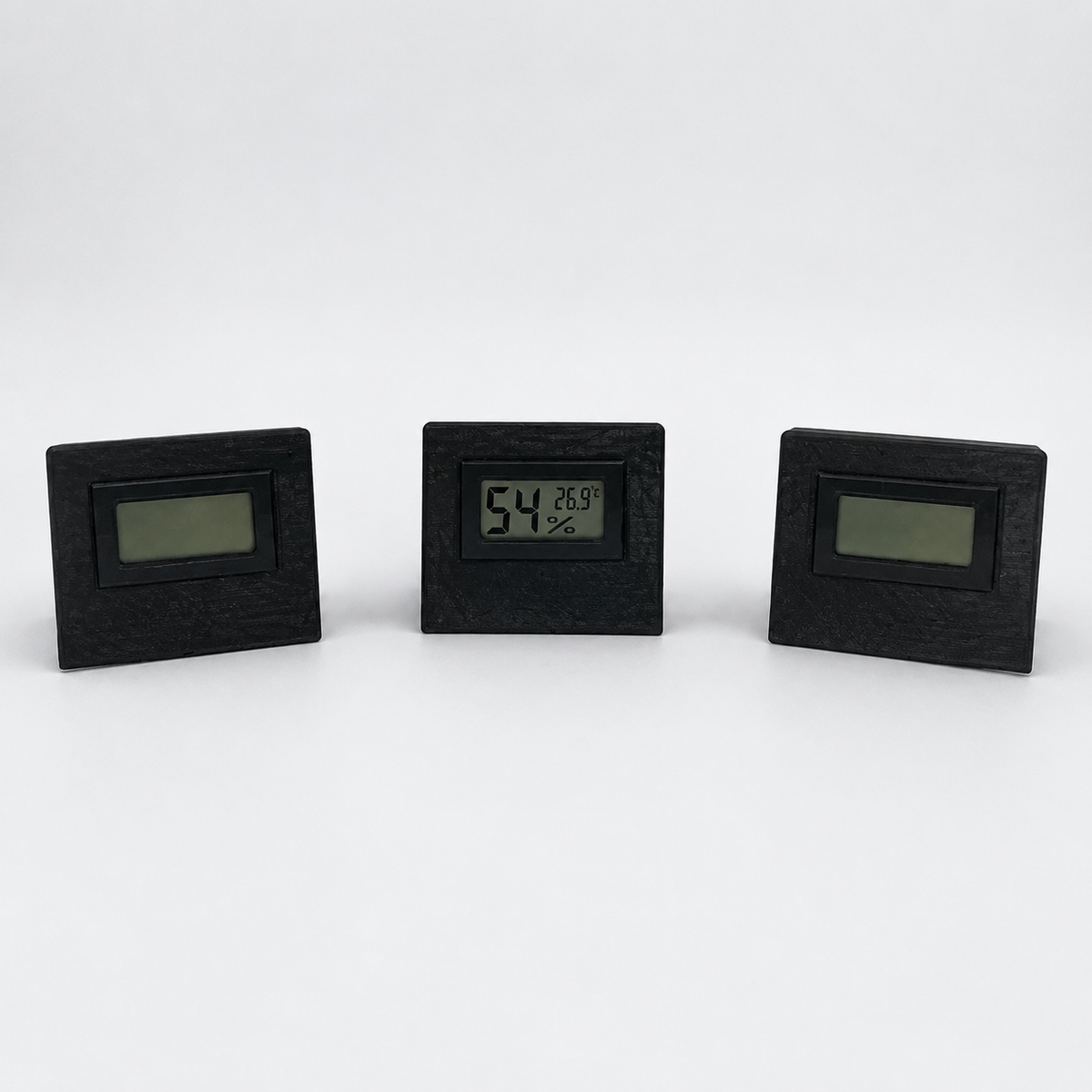Black temperature and humidity sensor shown from three front angles
