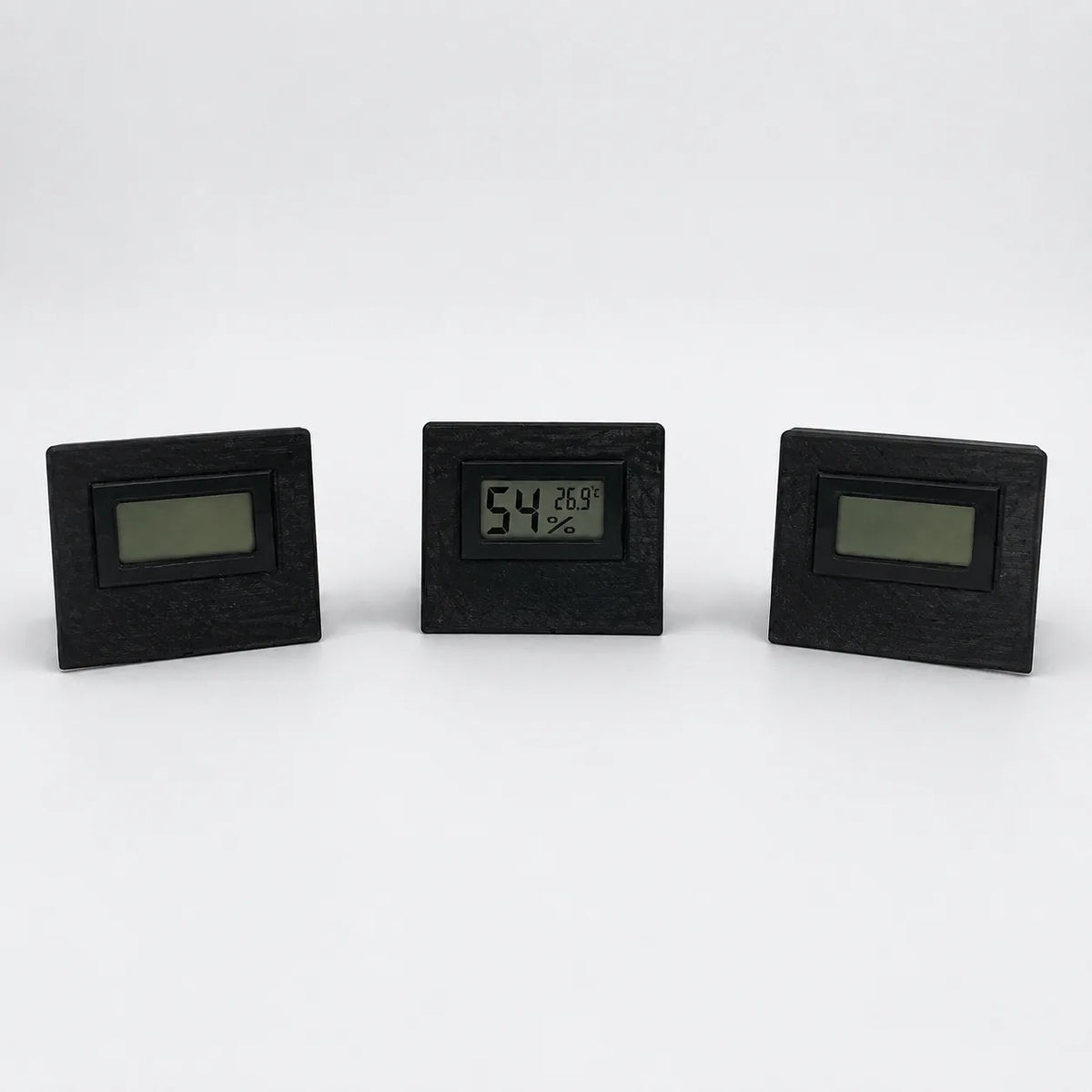 Black digital temperature and humidity sensor, three views