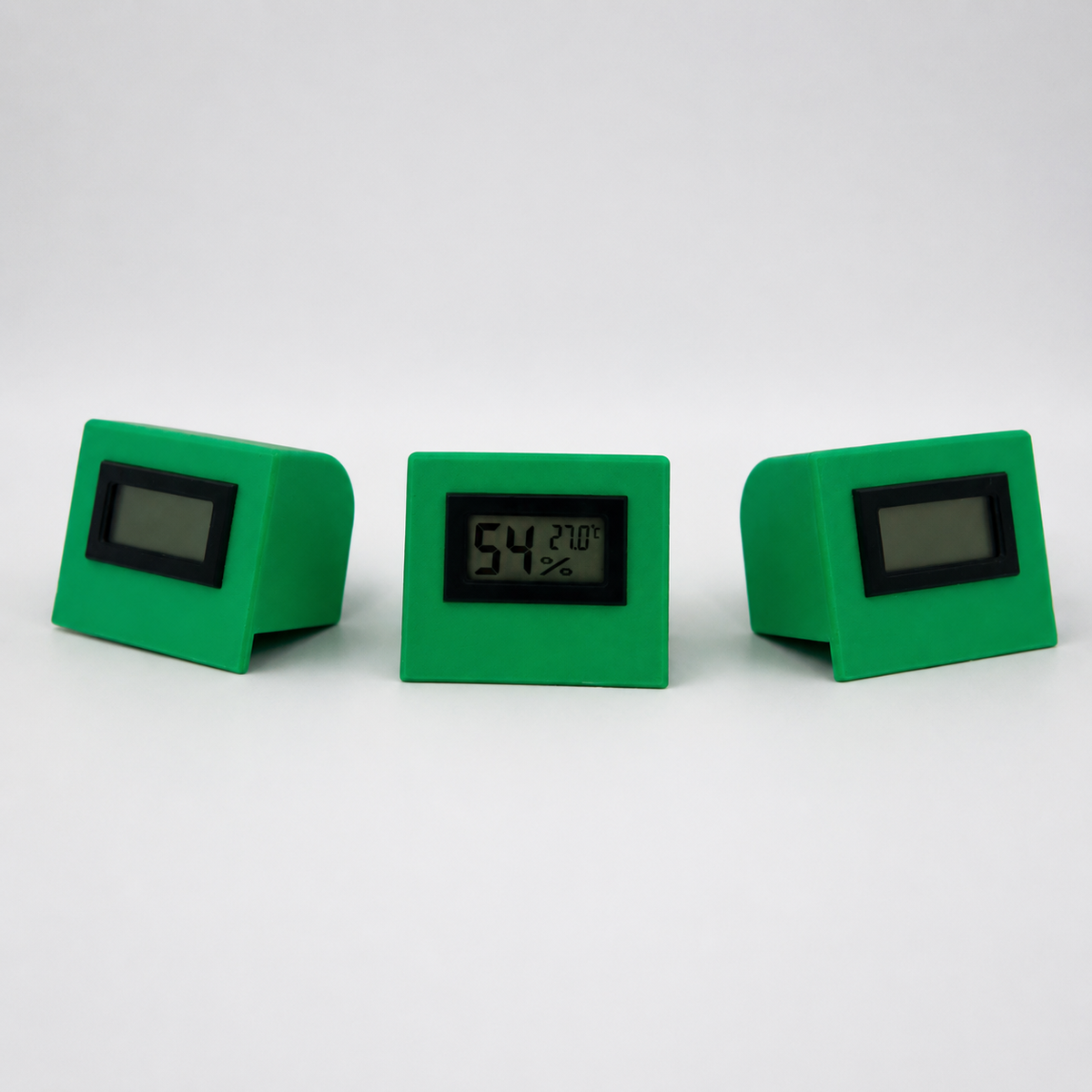 Green temperature and humidity sensor shown from three front angles