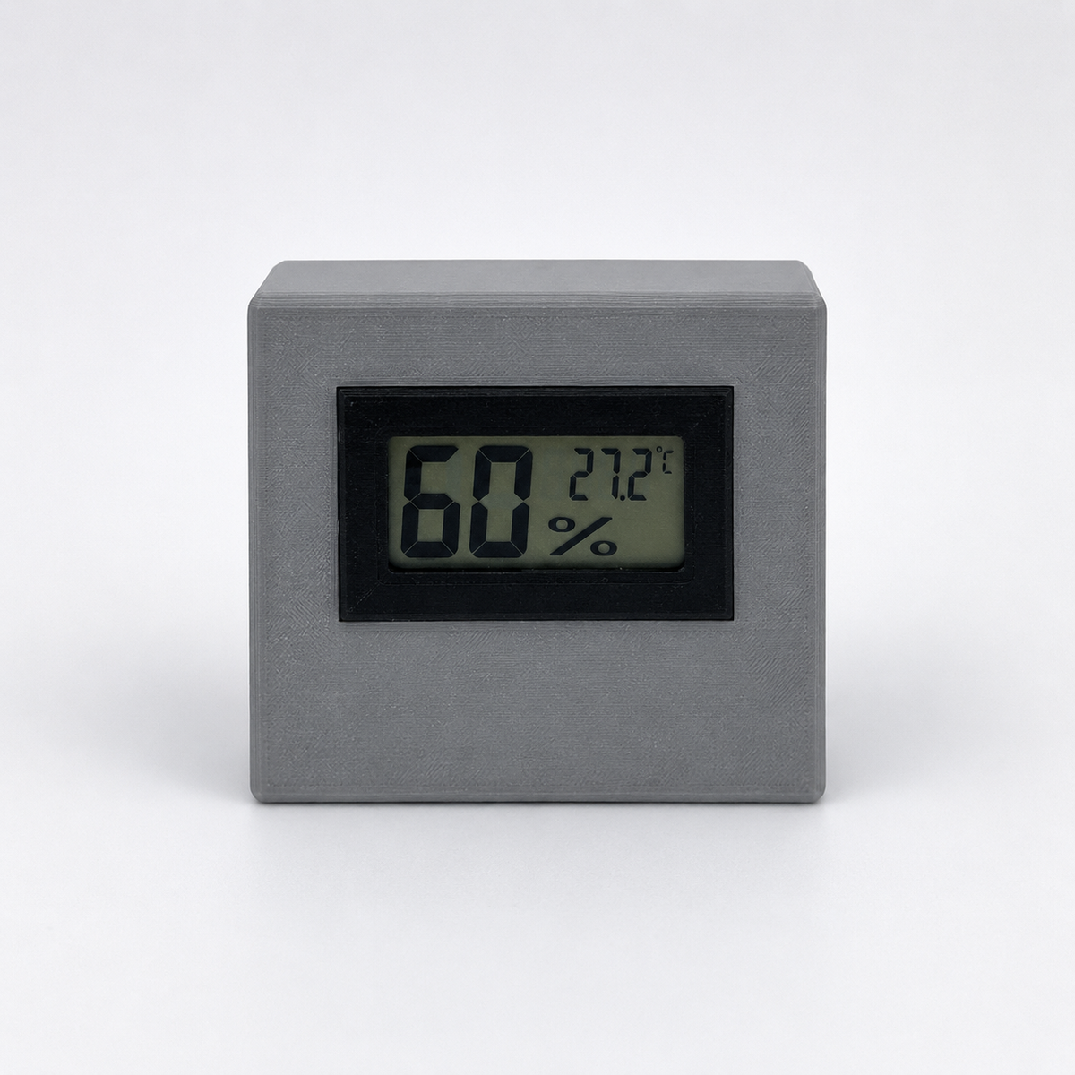 Grey digital temperature and humidity sensor, front view