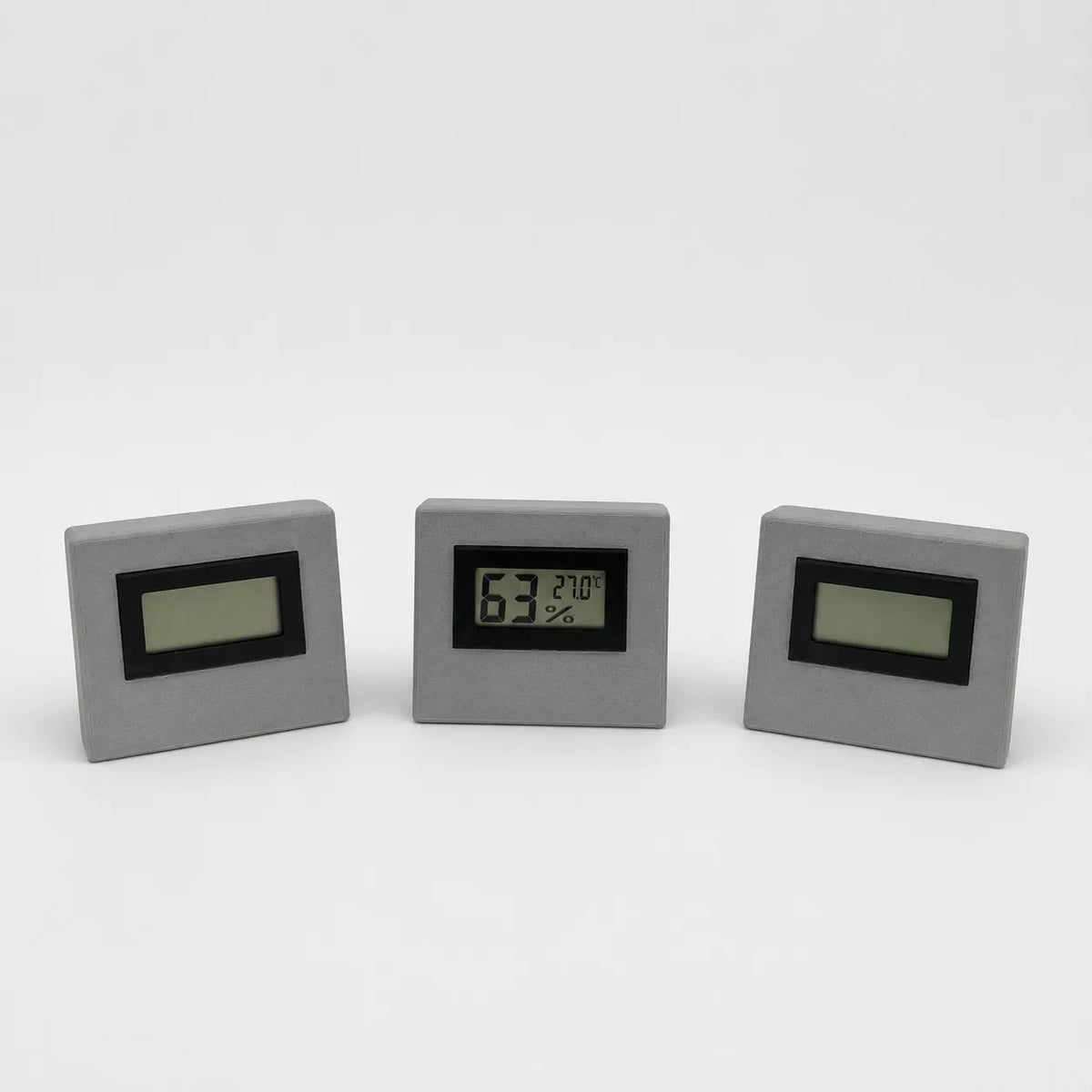 Grey digital temperature and humidity sensor, three views